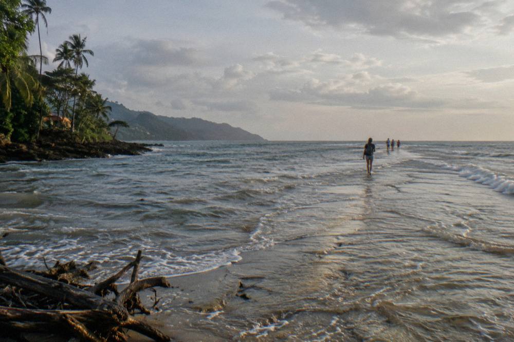 Long sandy beach curving into a sheltered bay with gentle waves at the shoreline