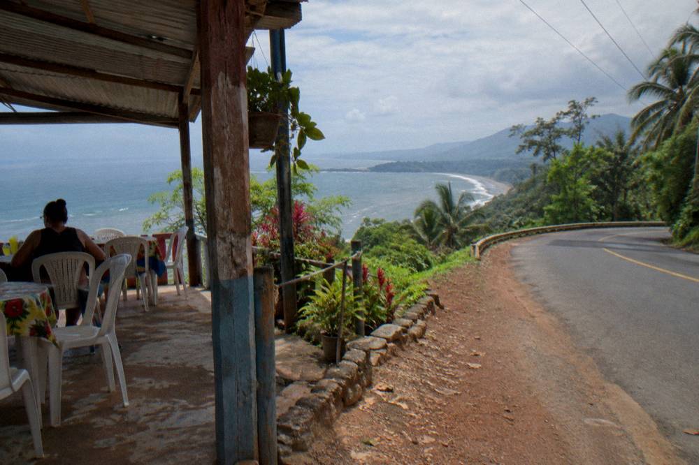 Coastal highway curving along green Osa hills above the ocean