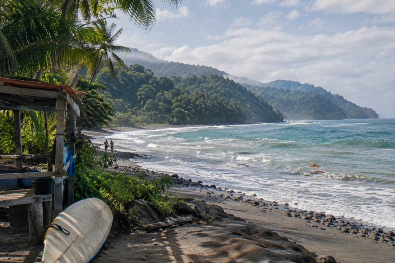 Forested Osa coastline meeting the Pacific ocean under morning light